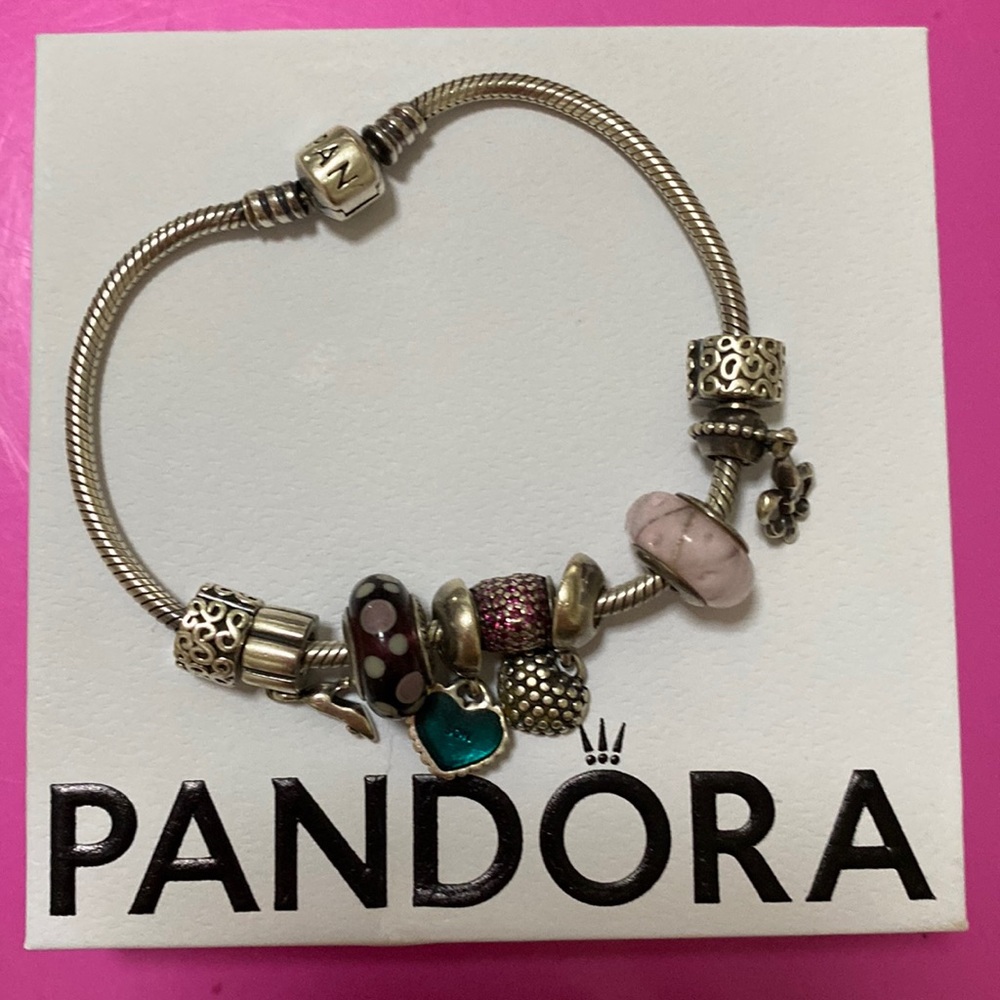 Pandora bracelet. Two end stoppers and 7 charms.